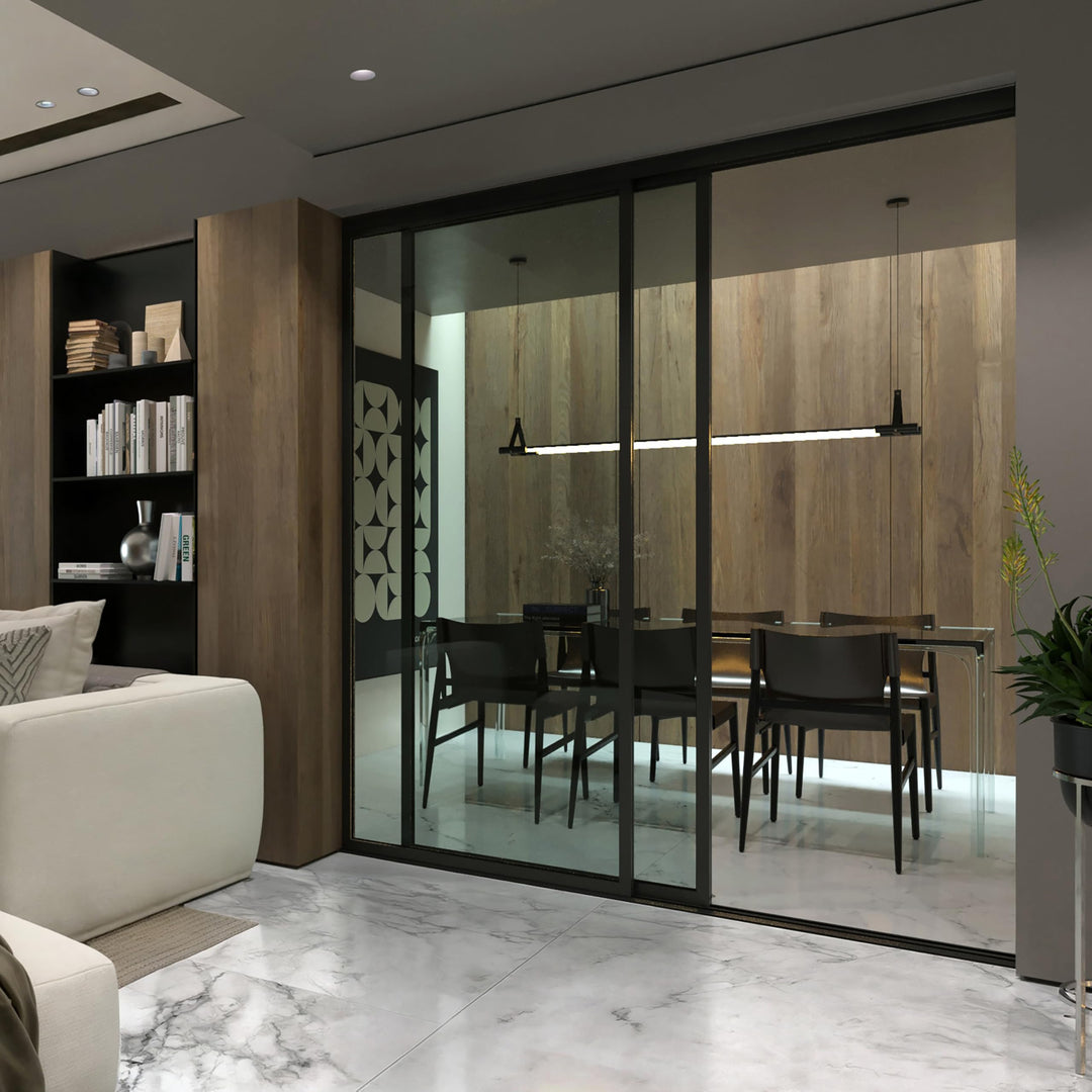 Glass room divider separating a living room and dining area