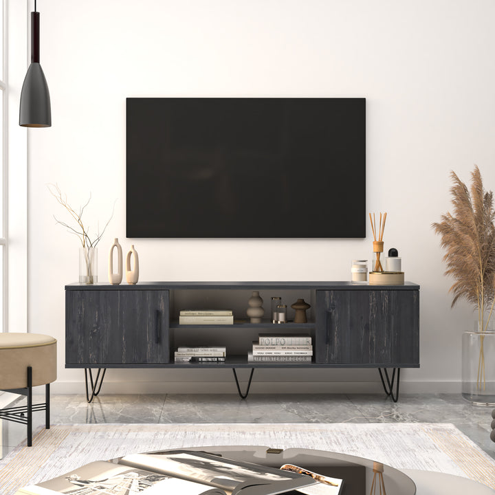 Linda 59'' Black Oak Media Console in a bright living room, perfect for organizing and showcasing a 65-inch TV.